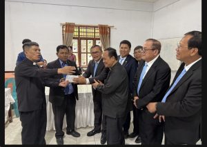 Foto 24. Penyerahan tali kasih Punguan Koor Ama HKBP Slipi sebesar Rp 10.000.000 kepada Pdt. Thomson Sinaga dari HKBP Balige pada acara ramah-tamah di ruang serbaguna, Minggu 26 Juli 2026 — Rp 2.000.000 untuk huria dan Rp 8.000.000 untuk pembangunan gereja.Sebelum melanjutkan perjalanan, rombongan kembali sejenak ke penginapan untuk berkemas. Di halaman depan Lakeside Haus, masih lengkap dengan busana ibadah, sempat diabadikan foto bersama pelayan gereja yang mendampingi kebaktian pagi itu.